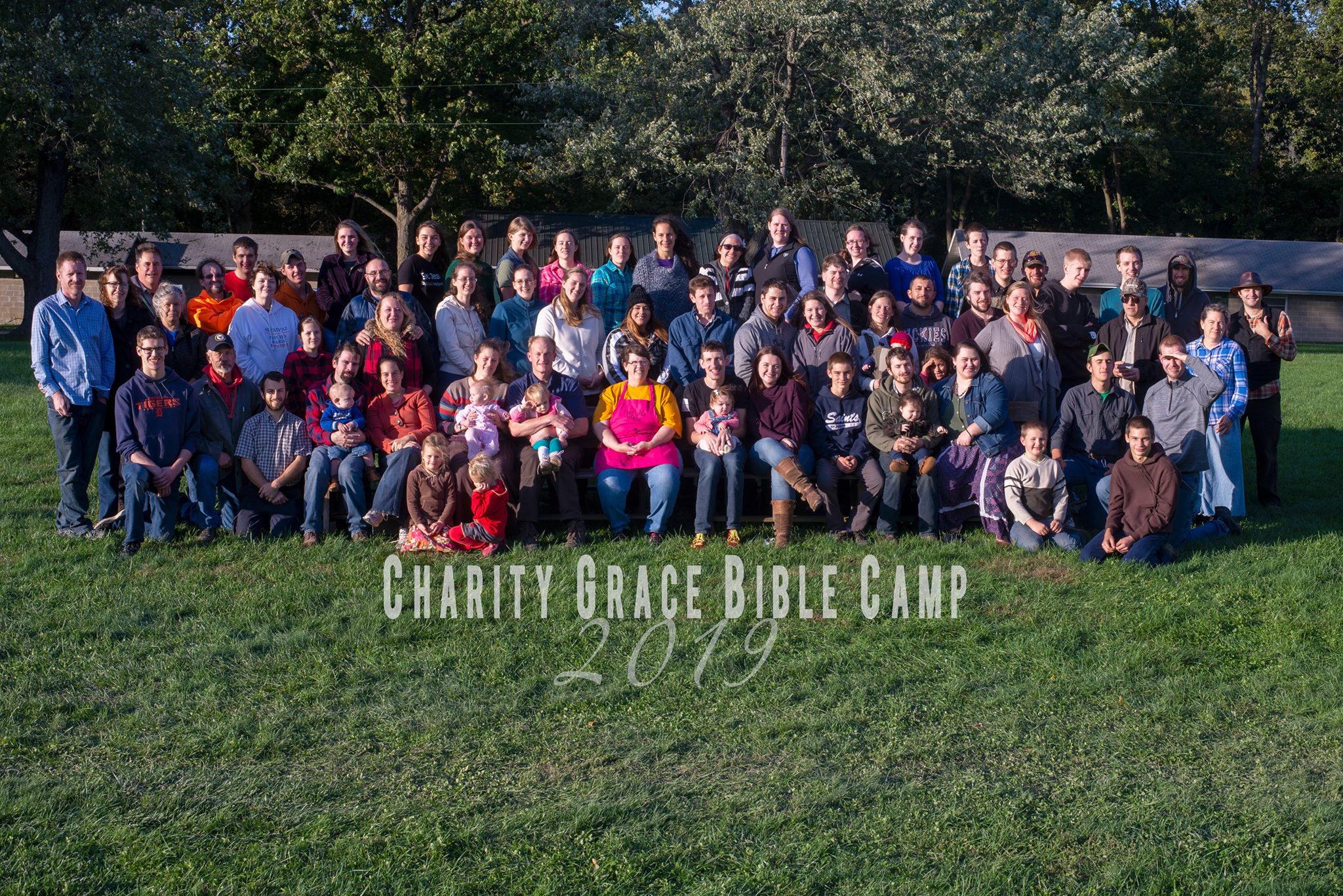 A group of people stand in front of a chapel.