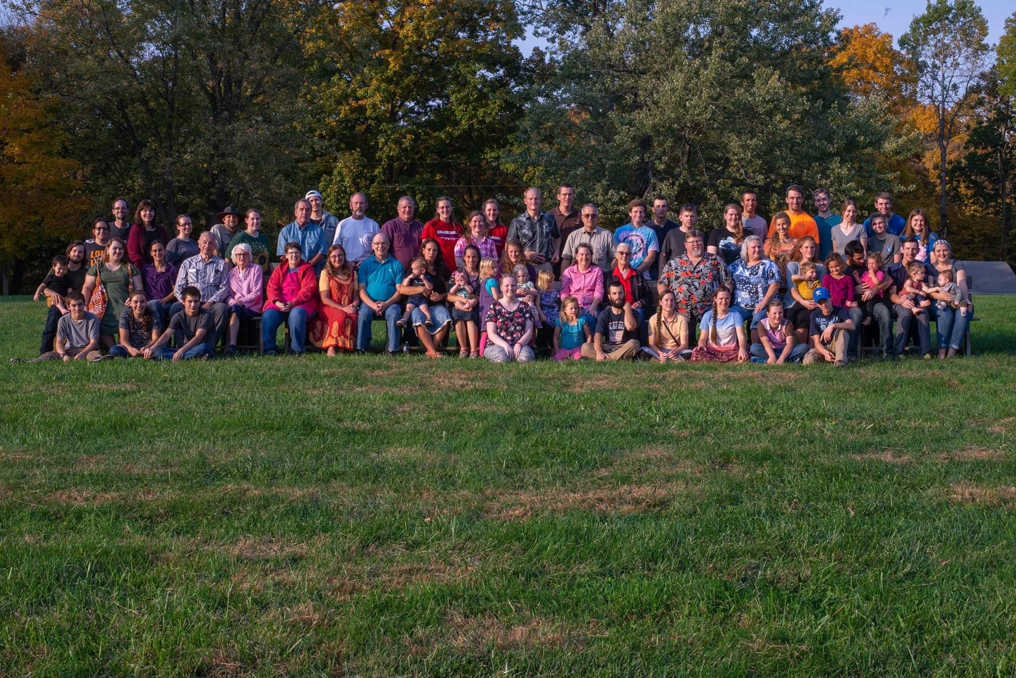 A group of people stand in front of a chapel.